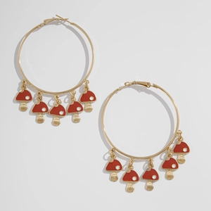 Detail of gold hoop earrings featuring five red enamel mushrooms with white dots