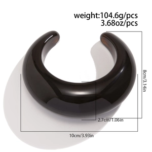 Detail of chunky brown acrylic bangle with weight and size measurements displayed