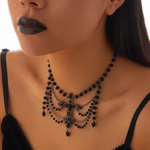 Close-up of gothic black beaded choker necklace with tiered chains and cross pendant