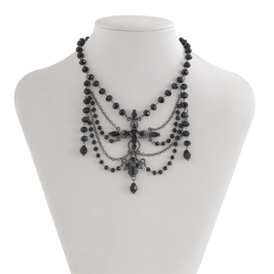 Gothic choker with black beads, cascading fringe chains, and central faceted gemstone