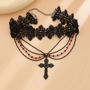 Detail of gothic lace choker with red beads and a vintage metal cross pendant