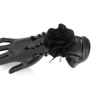 Detail of gothic black lace rose bracelet with three-layer beaded chains on model hand