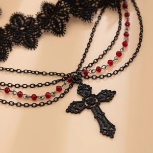 Detail of gothic lace choker with layered chains, red beads and large black metal cross