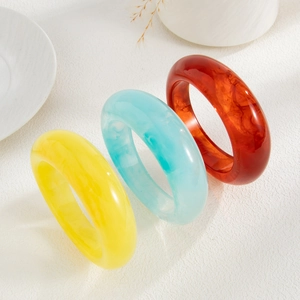 Detail of colorful acrylic resin bangles with translucent marble texture in 3-piece set