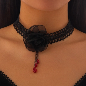 Detalle de gargantilla gótica de encaje con flores de hilo negro y colgante rojo