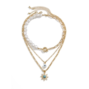 Detailsicht der dreilagigen Goldkette mit Anhängern aus Türkis-Sonne und Teufelsauge
