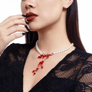 Detailed view of Gothic pearl choker with red crystal blood drip tassels on model