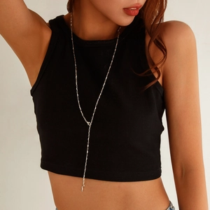 Silver Y-shaped layered chain necklace with geometric crystal pendant on female model