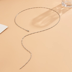 Macro shot of silver crystal Y-necklace with twisted metal links and lobster clasp detail