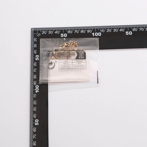 Golden tassel sequin necklace in clear packaging with fashion card and scale ruler