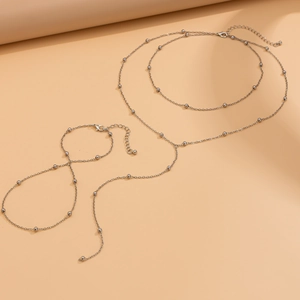 Detail view of silver layered body chain with delicate beads on a minimalist necklace