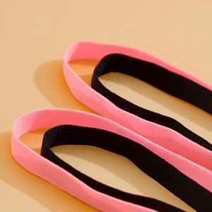 Close-up of elastic leg chain fabric texture in black and pink with soft weave