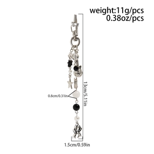 Detail view of silver punk keychain with electric guitar and spider charms with measurements