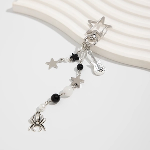Detail of sunflower guitar keychain set with white pearls and silver spider pendant