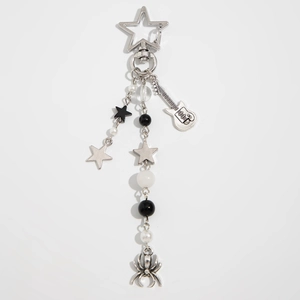 Gothic silver star keychain detail with spider pendant, guitar charm and beads