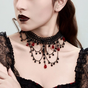 Close-up of Gothic black lace choker featuring red crystal beads and tiered tassels