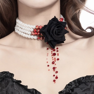 Detailed shot of layered pearl choker with black rose and red drop tassel beads