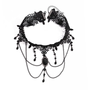 Detailed macro view of black lace choker with hanging teardrop beads and metal chains