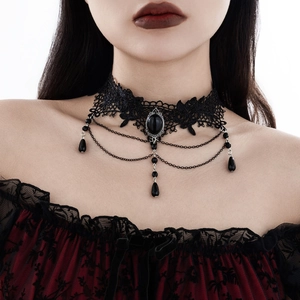 Close-up of gothic black lace choker with dark gemstone and layered teardrop tassels