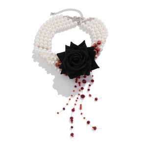 Multilayer pearl choker featuring a black rose flower and red bead tassel pendant