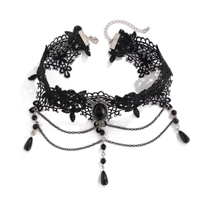 Detailed view of Gothic black lace choker featuring center gemstone and drop tassels