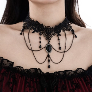 Detail of gothic black lace choker with dark gemstone pendant and tassel chains