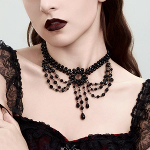 Macro detail of gothic layered black beaded necklace with teardrop crystal tassels
