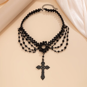 Macro view of Gothic black beaded necklace with vintage cross pendant and lace detail