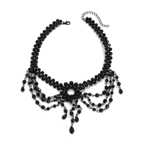 Vintage black lace choker necklace with gothic cross crystal tassels on white background