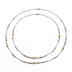 Detail of vintage long necklace with purple beads, flower spacers, and lobster clasp closure