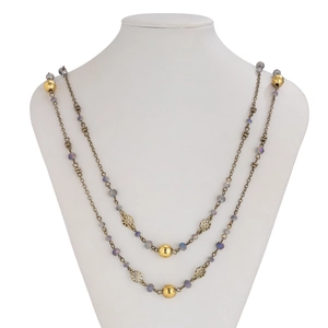 Detailed view of dual-layer pearl beaded necklace with gold flowers and purple beads