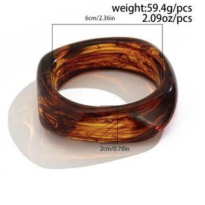 Detail view of amber resin bangle showing dimensions 6cm inner diameter and 59.4g weight