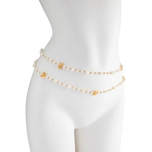 Detail of double-layer pearl long necklace with golden bow accents on a mannequin