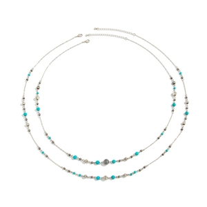 Detail of beaded long necklace with sky blue beads, textured silver balls and lobster clasp