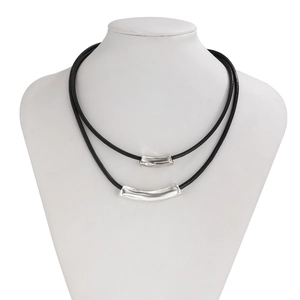 Close-up of double-layer necklace with silver curved metal tubes on black cord