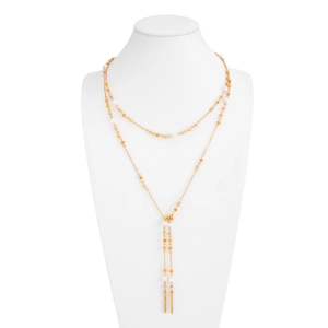 Golden multi-layer Y-shaped necklace with orange beads and white pearls on white bust