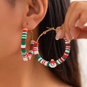 Christmas hoop earrings with colorful polymer clay beads and Santa Claus pendant on model