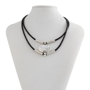 Detail of double-layer necklace featuring oval cutout pendant and silver metal tubes