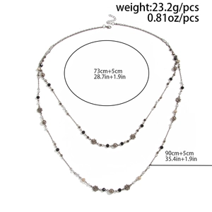 Detail showing layers of black beads and metal flowers with size and weight info