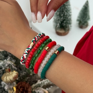 Détail de six bracelets de Noël en perles d'argile colorées avec charms étoile et lettre