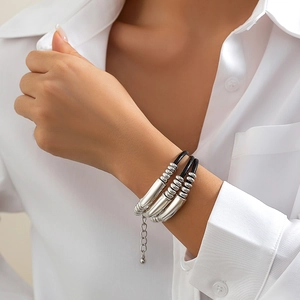 Minimalist multi-layer black cord bracelet with polished silver cylinders and beads