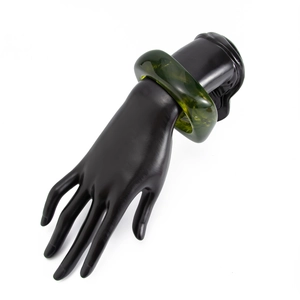 Detailed view of a dark olive green translucent acrylic bangle on a display stand