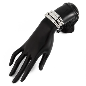 Detail of layered silver metal beads and curved bars on a black leather strand bracelet