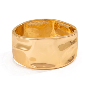 Golden wide open cuff bracelet with irregular hammered metal texture and hinge closure
