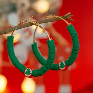 Christmas hoop earrings with green heishi beads and festive tree pattern bead charms