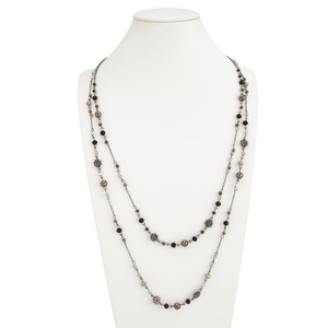 Detail of bohemian double-layered necklace with flower pendants and crystal beads