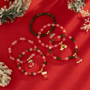 Close-up of 5-piece Christmas beaded bracelet set with Noel charms and festive ornaments