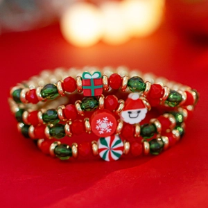Macro shot of Christmas beaded bracelets with Santa Claus and snowflake pendants