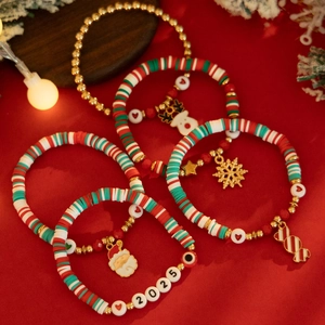 Detail view of 5-piece Christmas bead bracelets with 2025 charms and festive clay beads