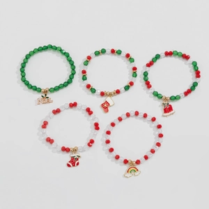 Detailed view of five Christmas beaded bracelets with festive charms and NOEL pendant